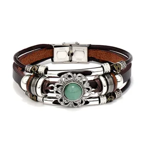 Detail view of multi-layer braided leather bracelet with green stone and steel clasp