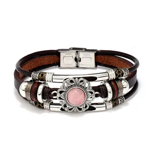 Detail of multi-layer leather bracelet with pink gemstone and stainless steel clasp