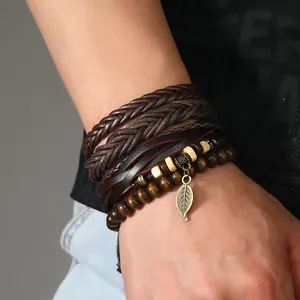 Detail von mehrlagigen Lederarmbändern mit Holzperlen und Vintage Blatt-Anhänger