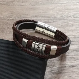 Dettaglio bracciale da uomo in pelle con motivi a foglia incisi e chiusura magnetica