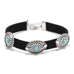 Detail of punk PU leather choker featuring vintage silver flowers and turquoise beads