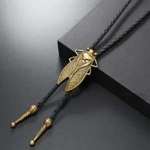 Vintage bronze cicada bolo tie with black braided leather cord and engraved metal tips