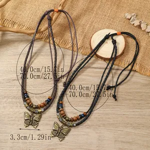 Detail of adjustable butterfly pendant necklaces with wood beads and rustic woven cords