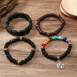 Detail of bohemian wood bead bracelets with colorful chakra stones and tree of life charm