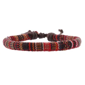 Detail of multi-color woven dragonfly bracelet with adjustable brown cord strap