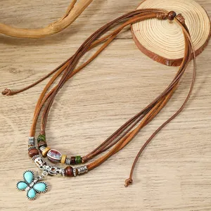Bohemian multilayer beaded necklace featuring a turquoise butterfly pendant and wood beads