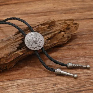 Cravate Bolo vintage avec boucle en métal gravé et cordon en cuir tressé noir robuste