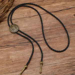 Cravate Bolo vintage avec médaillon floral en bronze et cordon noir en cuir tressé