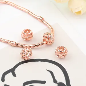 Rose gold snake chain bracelet featuring hollow woven charms and sparkling crystal accents