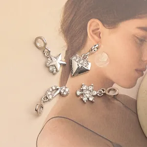 Detail of silver lightning energy pendants with micro-set rhinestones for DIY jewelry