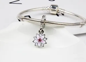 Primer plano de pulsera de cadena de serpiente plateada con dije de flor de magnolia