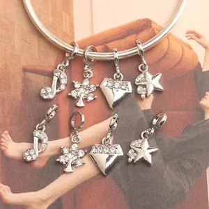 Silver alloy charms set with music notes, stars, and crystals on a stylish bracelet