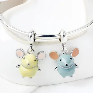 Close-up of cute enamel mouse charms in blue and yellow on a silver bracelet