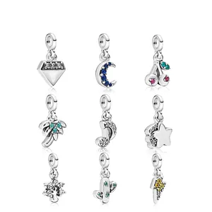 Macro detail of nine assorted silver-toned alloy charms with colorful zircon inlays