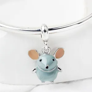 Macro view of blue enamel cartoon mouse pendant hanging on a silver bracelet