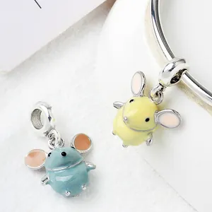 Macro shot of cute enamel mouse charms in blue and yellow on a silver bracelet