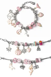 Macro view of silver and pink DIY charm bracelets with heart, unicorn, and moon pendants