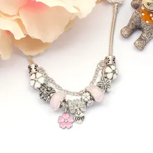 DIY charm bracelet with pink magnolia flowers, love heart pendant and sparkling crystals