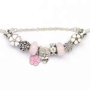 Silver charm bracelet featuring pink glass beads and a LOVE heart pendant on snake chain