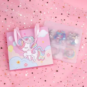 Detail of pink unicorn gift bag and DIY bead set in a transparent storage case