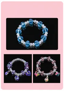 Close-up of faceted crystal beaded bracelets with heart and butterfly pendants