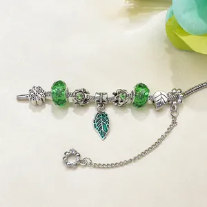 DIY silver snake chain bracelet with green clover pendant and forest-style glass beads