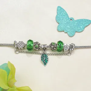 Pastoral silver snake chain bracelet with green enamel leaf charms and glass beads