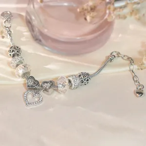 Elegant silver-toned charm bracelet with heart pendant and sparkling crystal beads