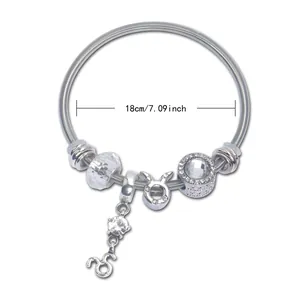 Detailed view of silver beaded bracelet with Taurus charm and crystal accents