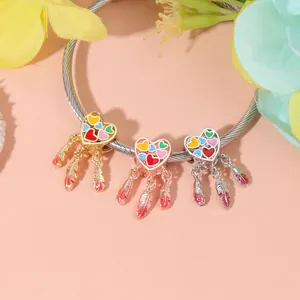 Colorful dreamcatcher heart charms with feather tassels on a silver rope bracelet