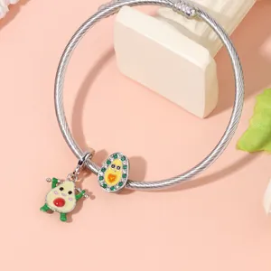 Silver stainless steel wire bracelet featuring cute avocado charms and green crystals