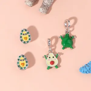 Macro shot of avocado charms with green stones and enamel finish for DIY jewelry