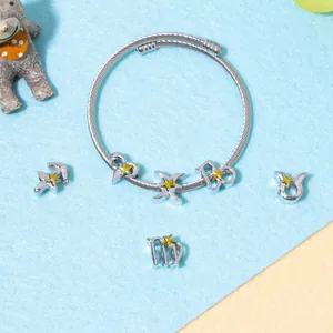 Silver zodiac charm bracelet set with woven texture and yellow star pendants