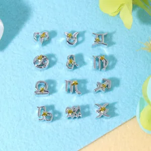Macro view of twelve zodiac alloy charms with yellow stars for DIY jewelry sets