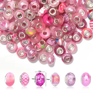 Detailed macro view of pink resin faceted spacer beads with silver metal core for DIY crafts