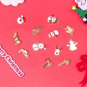 Detail of Christmas themed enamel charms showing gold alloy backing and vibrant festive colors