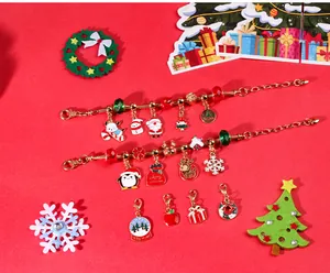 Close-up of Christmas charm bracelet set with Santa, reindeer pendants on red background