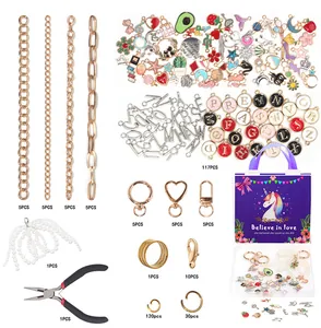 Detailed DIY jewelry making kit with golden chains, colorful pendants and a purple unicorn box