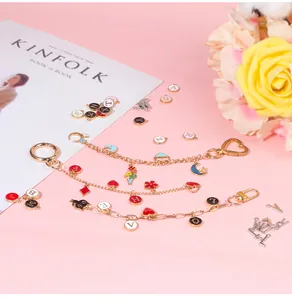 DIY jewelry making kit featuring gold enamel alphabet charms and heart chains