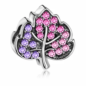 Detailed view of silver tree leaf charm with purple and pink pavé cubic zirconia