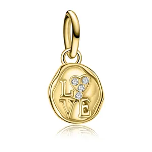 Detail of gold LOVE tree of life pendant with heart-shaped zircon stones and polished bail