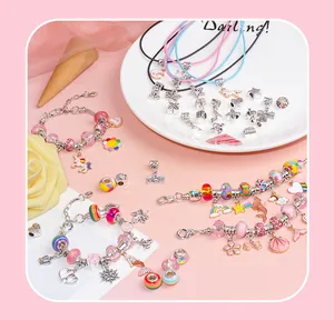 Close-up of pink DIY jewelry making kit with beads, unicorn charms, and bracelets