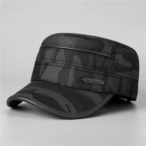 Detail of winter camo military cap featuring black leather piping and metallic brand plate