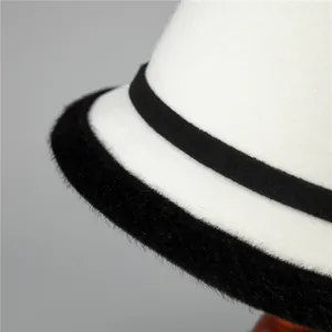 Elegant ivory wool felt bowler hat for women with black faux fur trim and ribbon detail