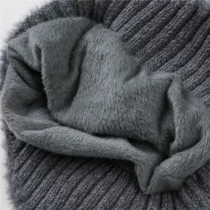 Detail van warme winter gebreide muts met dikke grijze pluche voering voor isolatie
