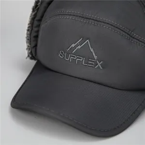 Detail of Supplex embroidery and gray faux fur lining on a winter thermal trapper hat