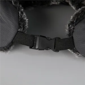 Detail view of adjustable plastic buckle and warm faux fur lining on a winter trapper hat