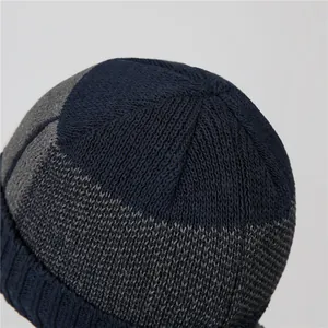 Detailed close-up of navy and grey knit pattern on warm men's winter beanie hat