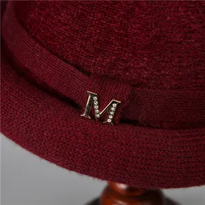 Elegant wine red knitted winter hat for elderly women with rhinestone M metal decor