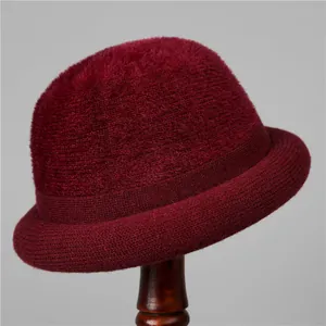 Close-up of wine red knitted bucket hat showing thick texture and soft velvet finish